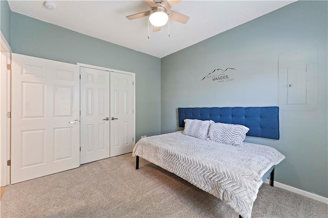 carpeted bedroom with a closet, ceiling fan, and baseboards