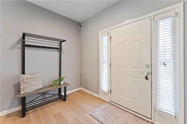 entryway featuring light wood-style floors and baseboards