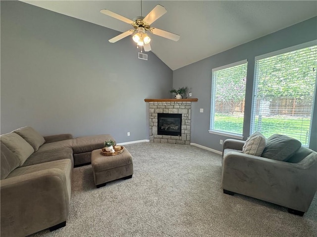 living room with ceiling fan, a glass covered fireplace, vaulted ceiling, carpet flooring, and baseboards