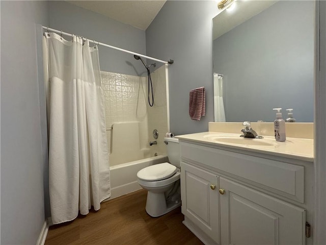 bathroom featuring toilet, shower / bath combo, wood finished floors, and vanity