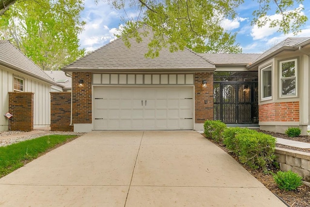 view of front of home featuring driveway, an attached garage, a shingled roof, and brick siding