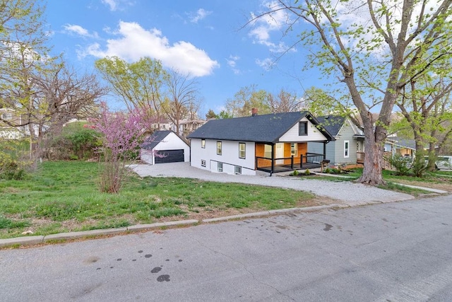 modern farmhouse style home with an outbuilding, a detached garage, and covered porch