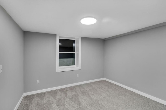 carpeted empty room with baseboards