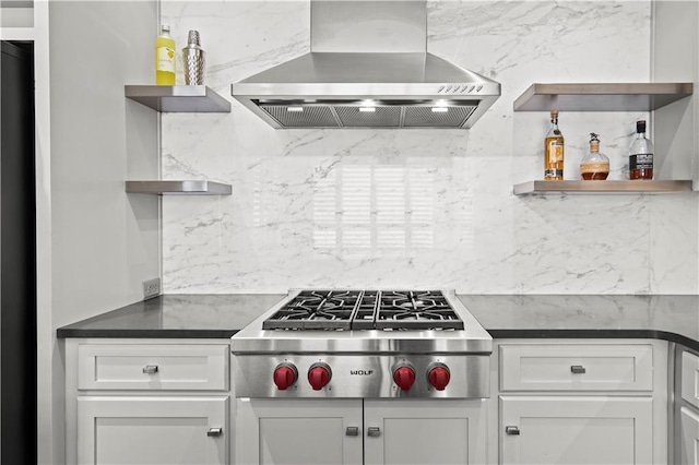 4924 Central St, Kansas City, MO 64112 - kitchen with stainless steel gas cooktop, tasteful backsplash, dark countertops, wall chimney range hood, and open shelves