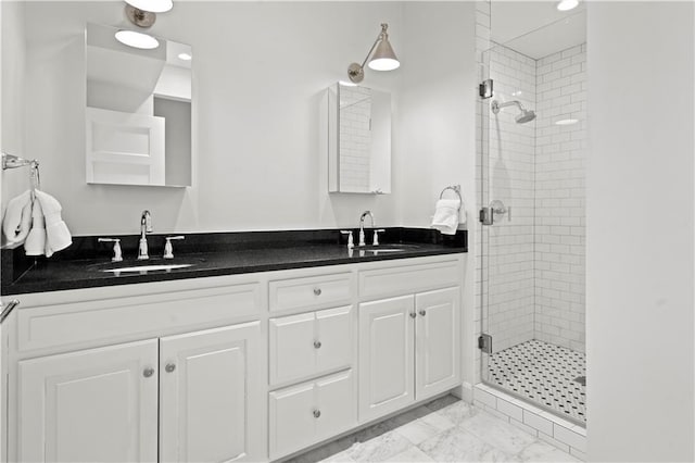 4924 Central St, Kansas City, MO 64112 - full bathroom with double vanity, marble finish floor, a stall shower, and a sink