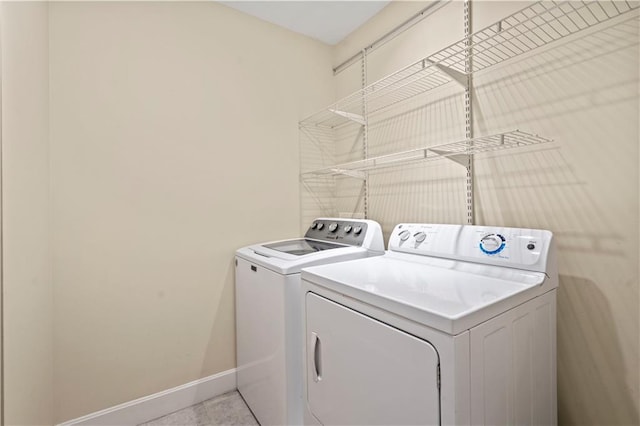 4924 Central St, Kansas City, MO 64112 - washroom featuring washing machine and clothes dryer, baseboards, and laundry area