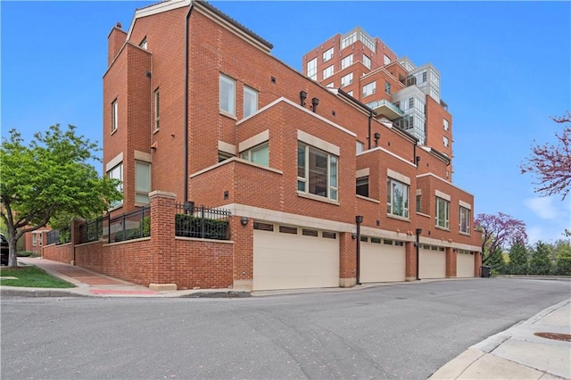 4924 Central St, Kansas City, MO 64112 - view of building exterior with a garage