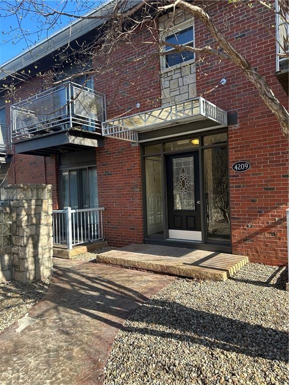 4209 Clark Ave Unit 4209-4, Kansas City, MO 64111 - property entrance with brick siding and a balcony