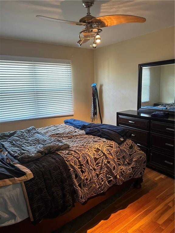 4209 Clark Ave Unit 4209-4, Kansas City, MO 64111 - bedroom with a ceiling fan and wood finished floors