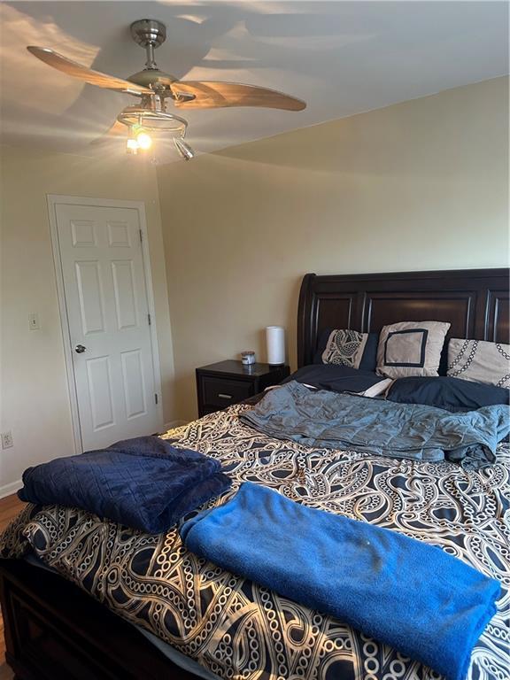 4209 Clark Ave Unit 4209-4, Kansas City, MO 64111 - bedroom featuring a ceiling fan and wood finished floors
