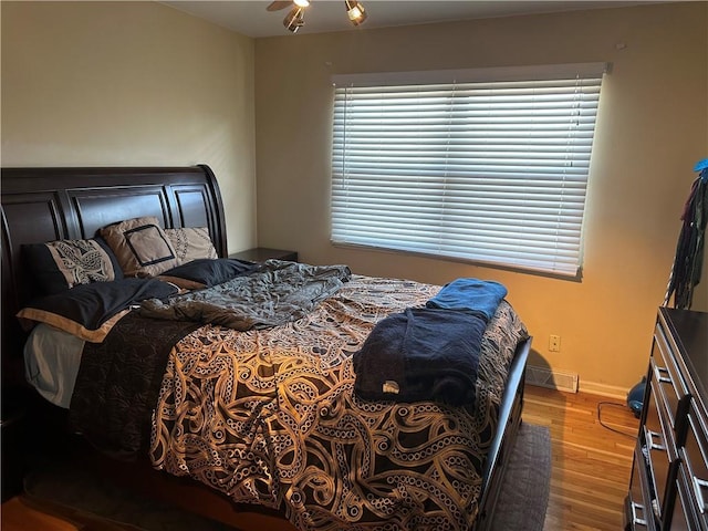 4209 Clark Ave Unit 4209-4, Kansas City, MO 64111 - bedroom featuring visible vents, baseboards, and wood finished floors