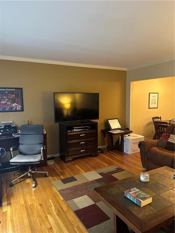 4209 Clark Ave Unit 4209-4, Kansas City, MO 64111 - living room with ornamental molding, baseboards, and wood finished floors