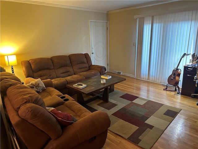4209 Clark Ave Unit 4209-4, Kansas City, MO 64111 - living area featuring crown molding, visible vents, and wood finished floors