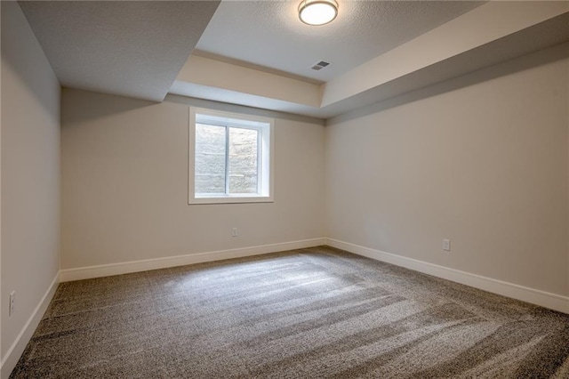 8216 NW 89th Ter, Kansas City, MO 64153 - empty room featuring visible vents, baseboards, a raised ceiling, and carpet floors