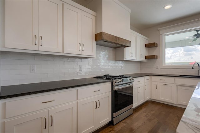 8216 NW 89th Ter, Kansas City, MO 64153 - kitchen featuring white cabinetry, dark stone countertops, dark wood-style flooring, stainless steel gas range oven, and custom range hood