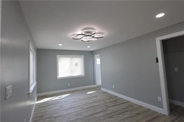 5606 N Indiana Ave, Kansas City, MO 64119 - spare room featuring baseboards, recessed lighting, and wood finished floors