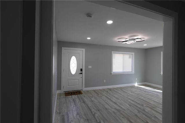 5606 N Indiana Ave, Kansas City, MO 64119 - foyer with baseboards, a wealth of natural light, and wood finished floors