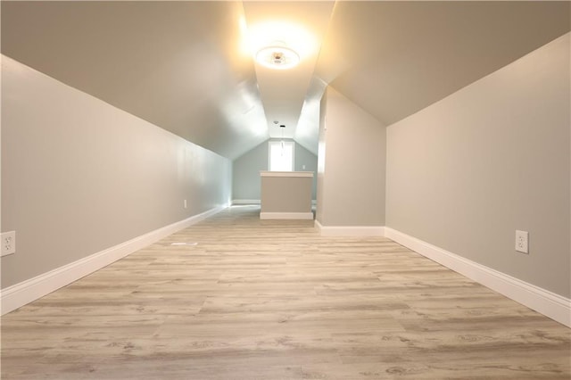 5606 N Indiana Ave, Kansas City, MO 64119 - additional living space with baseboards, vaulted ceiling, and light wood-style flooring