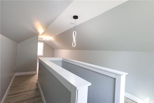 5606 N Indiana Ave, Kansas City, MO 64119 - interior space featuring baseboards, an upstairs landing, wood finished floors, and lofted ceiling