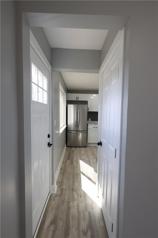 5606 N Indiana Ave, Kansas City, MO 64119 - hall with light wood-type flooring and baseboards