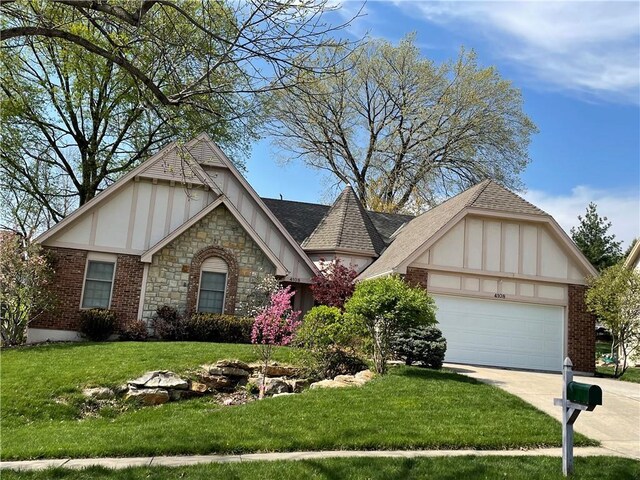 view of front of house featuring stone siding, concrete driveway, an attached garage, a front yard, and stucco siding