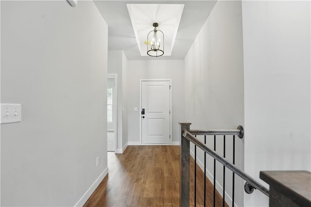 2433 NW Sunnyvale Ct, Blue Springs, MO 64015 - hall featuring an upstairs landing, a chandelier, wood finished floors, and baseboards