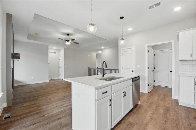 2433 NW Sunnyvale Ct, Blue Springs, MO 64015 - kitchen featuring a sink, dishwasher, a ceiling fan, wood finished floors, and light countertops