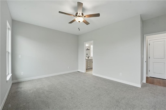 2433 NW Sunnyvale Ct, Blue Springs, MO 64015 - unfurnished bedroom with light colored carpet, baseboards, ensuite bath, and a ceiling fan
