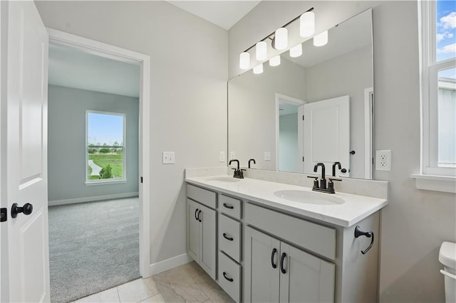 2433 NW Sunnyvale Ct, Blue Springs, MO 64015 - full bath featuring plenty of natural light, double vanity, baseboards, and toilet