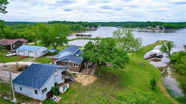 aerial view with a water view and a wooded view