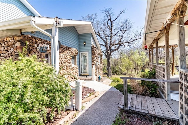 exterior space with stone siding