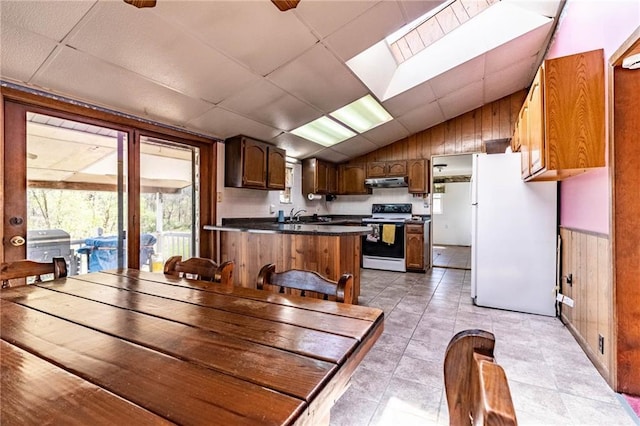 dining space featuring light tile patterned flooring and vaulted ceiling