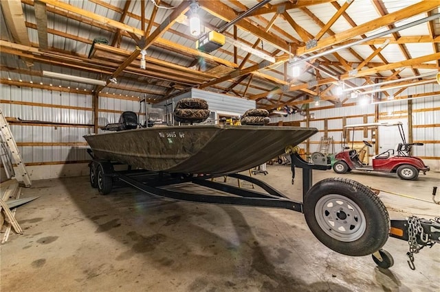 garage featuring a garage door opener and metal wall