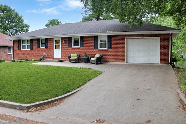 509 W 30th St, Higginsville, MO 64037 - ranch-style house featuring an attached garage, brick siding, concrete driveway, and a front yard