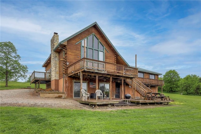 43 901st Rd, Clinton, MO 64735 - back of property featuring a yard, log exterior, a wooden deck, and a chimney