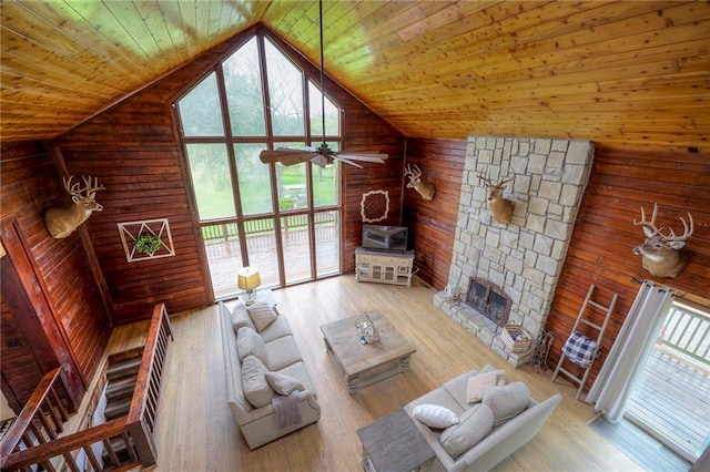 43 901st Rd, Clinton, MO 64735 - living area featuring wood finished floors, wood walls, a ceiling fan, and vaulted ceiling