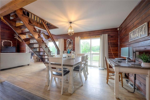 43 901st Rd, Clinton, MO 64735 - dining area with wood walls, stairway, a chandelier, and wood finished floors