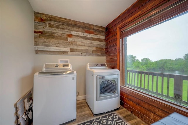 43 901st Rd, Clinton, MO 64735 - clothes washing area with wood walls, wood finished floors, washing machine and dryer, and laundry area
