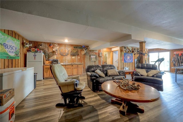43 901st Rd, Clinton, MO 64735 - living area featuring wooden walls, a textured ceiling, and light wood-type flooring