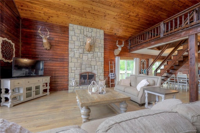 43 901st Rd, Clinton, MO 64735 - living room featuring wooden ceiling, wood walls, a fireplace, and wood finished floors