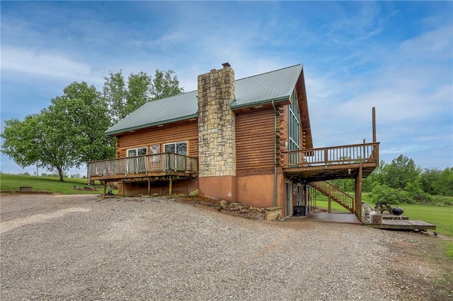 43 901st Rd, Clinton, MO 64735 - view of side of property with stairway, gravel driveway, log exterior, a deck, and metal roof