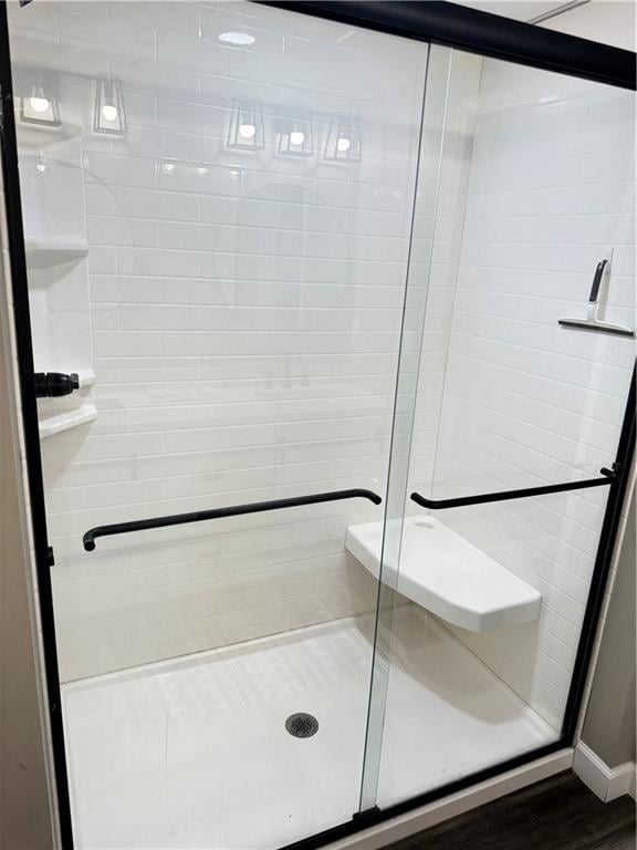 43 901st Rd, Clinton, MO 64735 - bathroom with a shower stall, a sauna, and wood finished floors