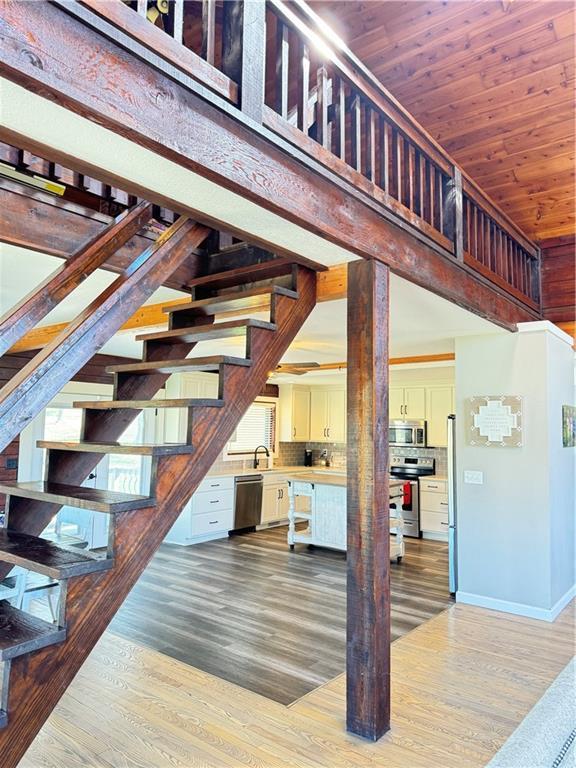 43 901st Rd, Clinton, MO 64735 - interior space with wood finished floors, baseboards, wooden ceiling, and stairway