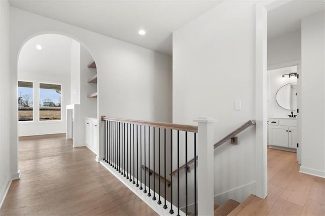 4967 146th St, Basehor, KS 66007 - hall featuring an upstairs landing, light wood-style floors, recessed lighting, and baseboards