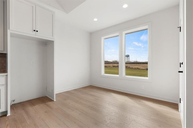 4967 146th St, Basehor, KS 66007 - unfurnished dining area with light wood finished floors, recessed lighting, and baseboards