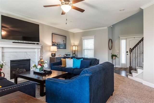 309 NE 102nd Ter, Kansas City, MO 64155 - carpeted living room with baseboards, stairs, ceiling fan, crown molding, and a tile fireplace