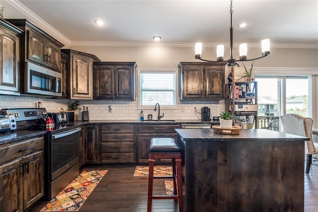 309 NE 102nd Ter, Kansas City, MO 64155 - kitchen featuring backsplash, a sink, a kitchen island, dark brown cabinetry, and appliances with stainless steel finishes