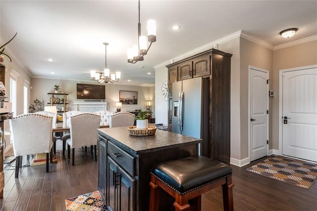309 NE 102nd Ter, Kansas City, MO 64155 - kitchen with a notable chandelier, stainless steel fridge with ice dispenser, dark countertops, a center island, and dark wood-style flooring