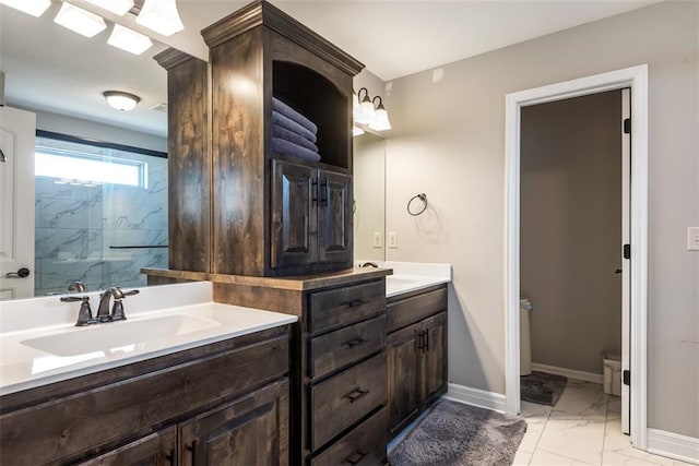 309 NE 102nd Ter, Kansas City, MO 64155 - bathroom with a sink, double vanity, baseboards, an enclosed shower, and marble finish floor