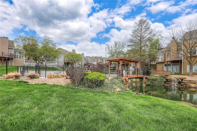view of yard featuring a gazebo, fence, and a residential view